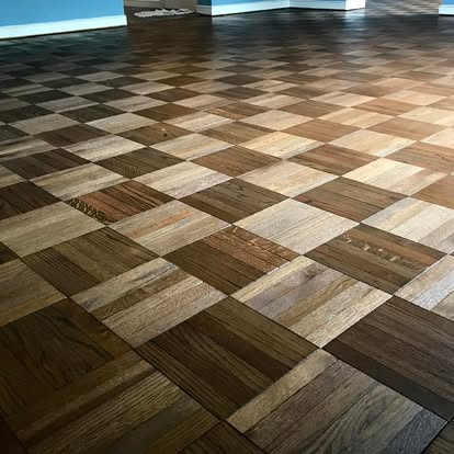 Custom checkerboard pattern hardwood flooring with mixed wood tones